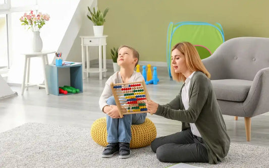 Autism support specialist working with a child in a learning environment, illustrating evidence-based understanding and challenging common misconceptions about autism.