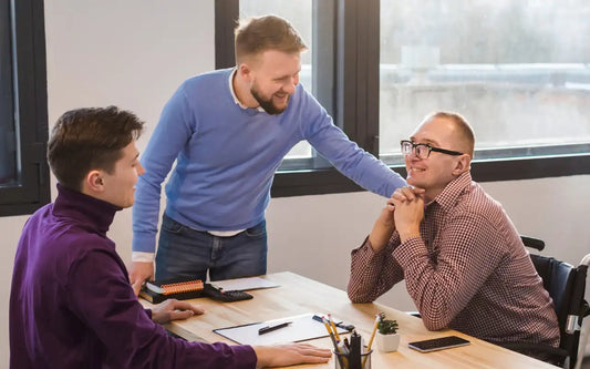 Manager engaging with neurodiverse employees in an inclusive office environment, demonstrating best practices for autism awareness, workplace accommodations, and employee support.